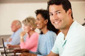 Man smiling in front of computer